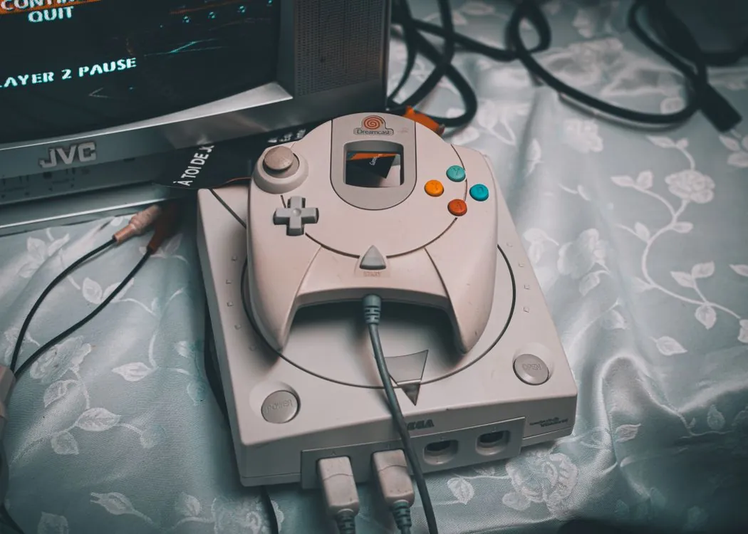 Retro Nintendo 64 style console with gray controller on desk