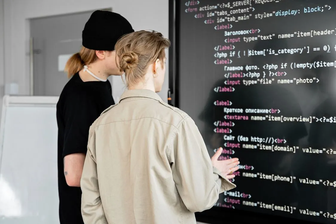 Team of developers reviewing code together in an office