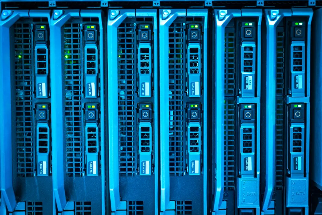 Rows of illuminated server racks in a data center running AI model inference
