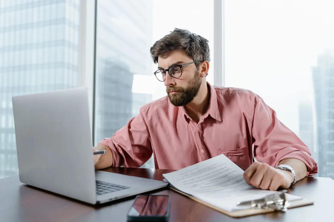 Professional reviewing AI API pricing documents at a desk