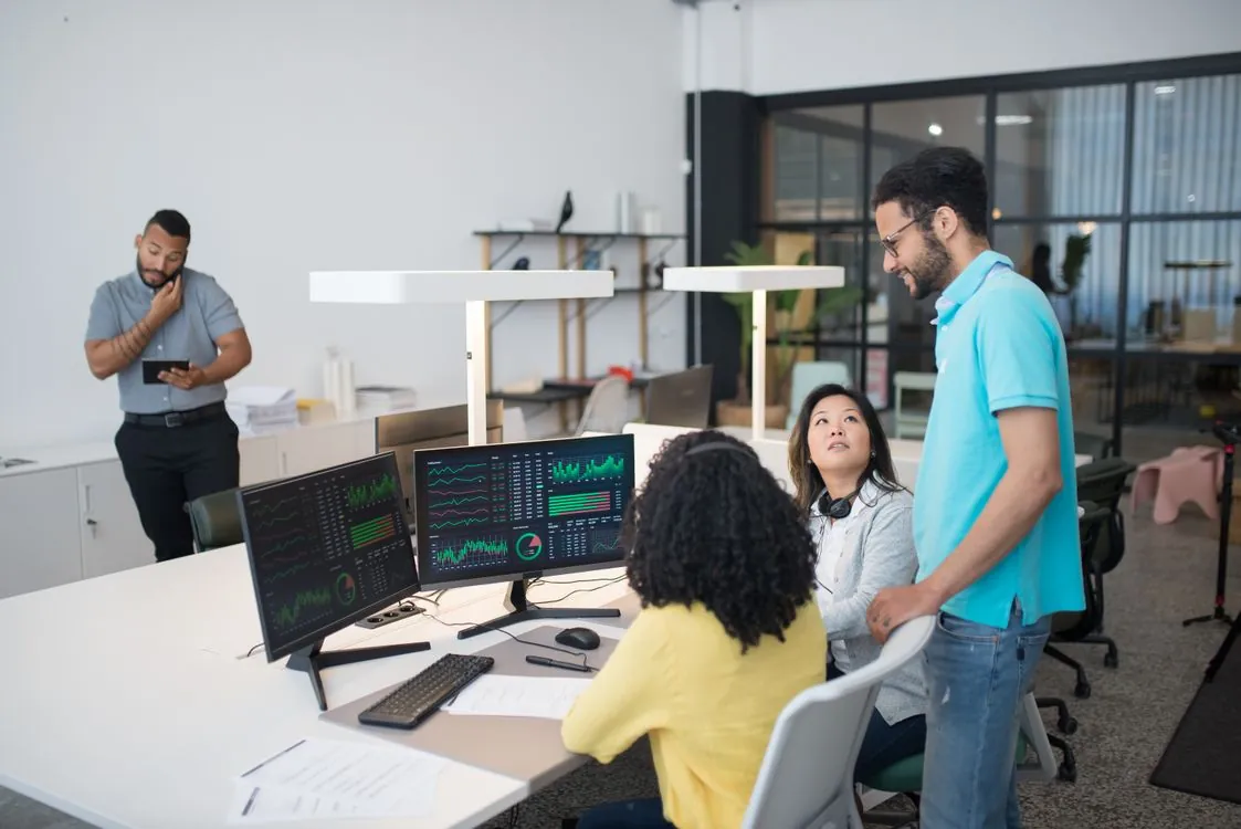 Enterprise employees collaborating around business data and productivity software