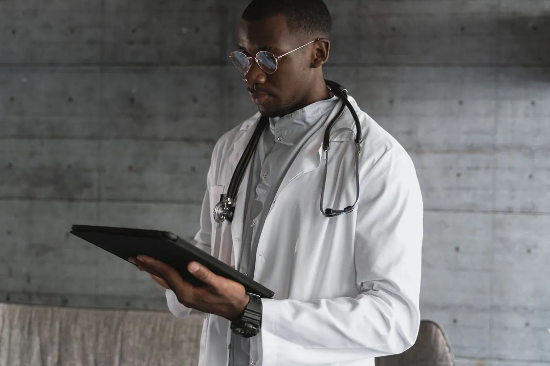 Healthcare professional reviewing patient records on a secure tablet