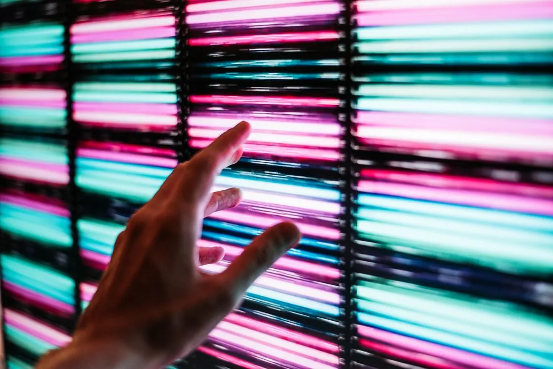 A colorful LED light installation glowing on an interior wall