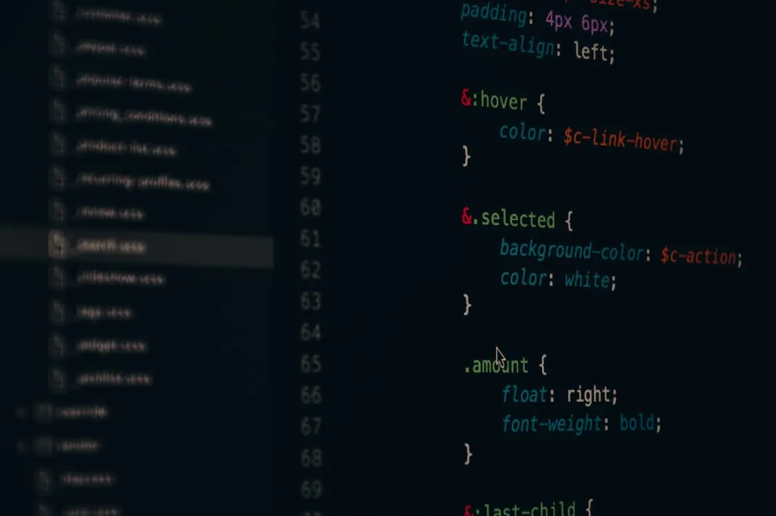CSS code on a laptop screen in a developer workspace