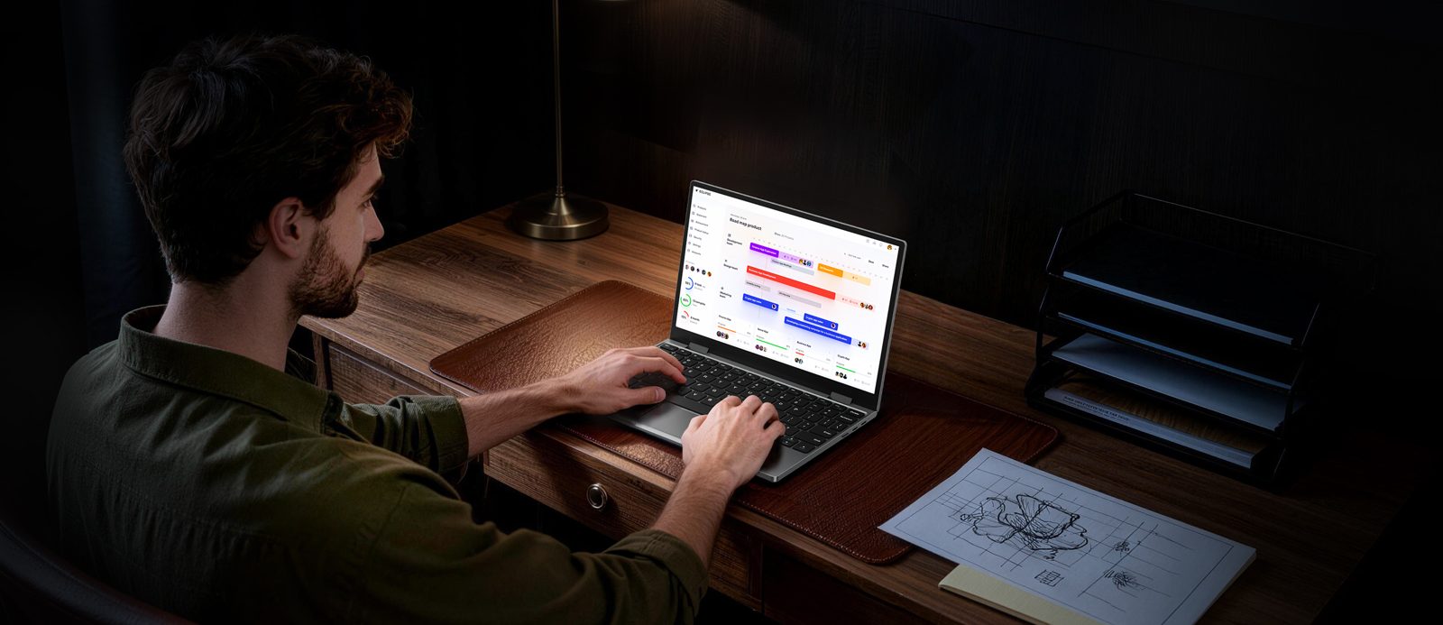 Person typing on a Chuwi MiniBook X in laptop mode at a wooden desk
