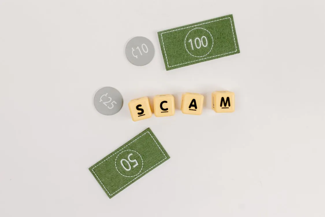 Flat lay of counterfeit money and fraudulent letters on a gray surface, symbolizing a Ponzi scheme built on moving deposits rather than real earnings