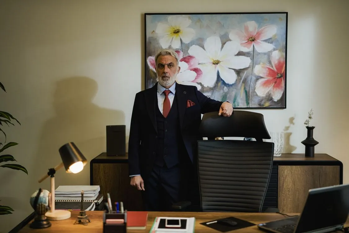 Polished executive persona of Ponzi mastermind